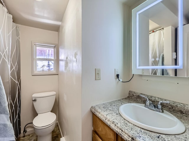 full bath with toilet and vanity