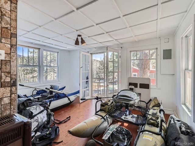 miscellaneous room featuring coffered ceiling and wood finished floors