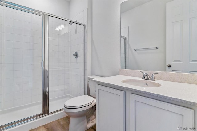 bathroom with vanity, hardwood / wood-style floors, toilet, and walk in shower