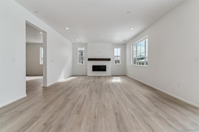 unfurnished living room featuring light wood-type flooring