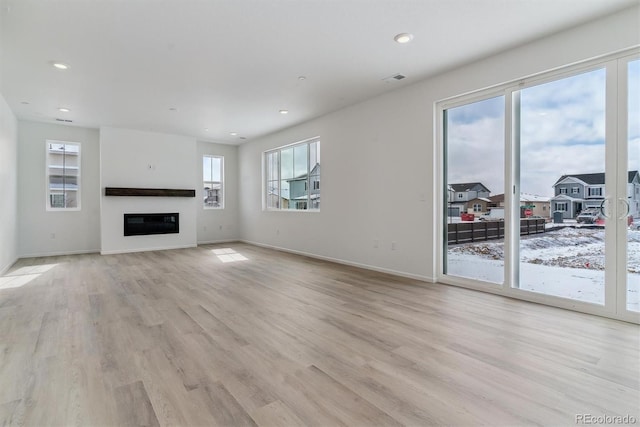 unfurnished living room with light wood-type flooring