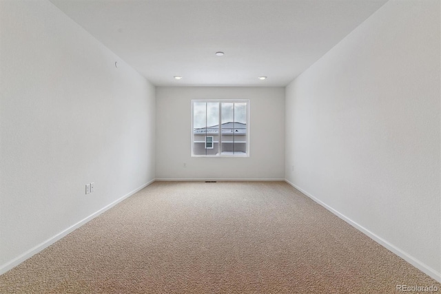 unfurnished room featuring carpet