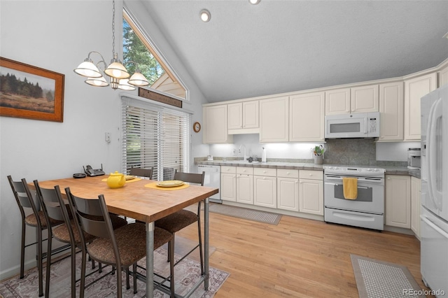 649 Cottonwood Dr, Evergreen, CO 80439 - kitchen with white appliances, a chandelier, white cabinets, light wood-style flooring, and backsplash