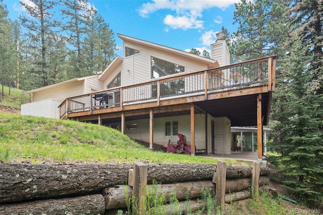 649 Cottonwood Dr, Evergreen, CO 80439 - rear view of house featuring a deck and a chimney