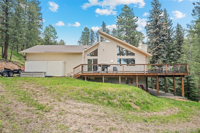 649 Cottonwood Dr, Evergreen, CO 80439 - back of house with a wooden deck, a chimney, and a lawn