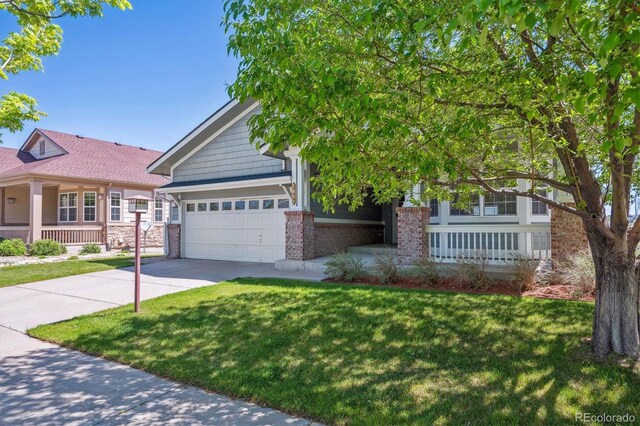 view of front of property with driveway, a front lawn, a garage, and brick siding