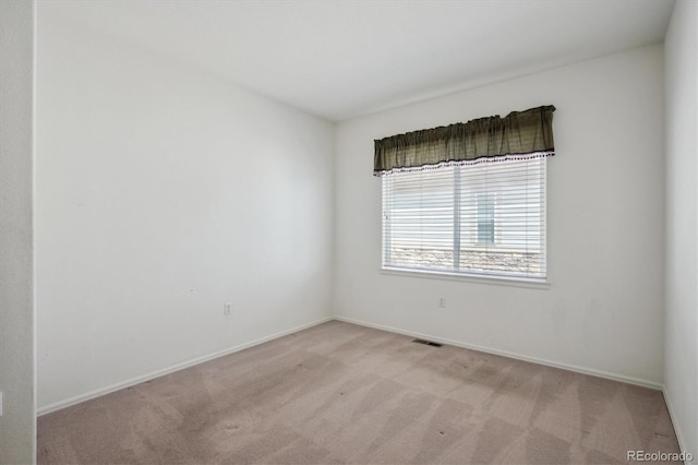 empty room with carpet floors and baseboards