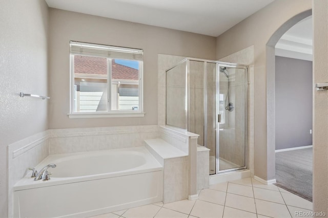 bathroom with tile patterned floors, a shower stall, and a garden tub