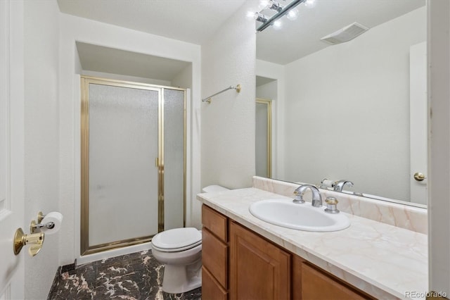 bathroom featuring a shower stall, toilet, and vanity