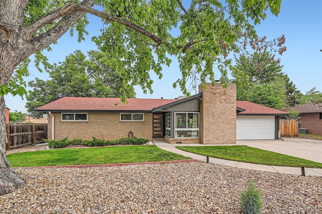 7491 W 45th Ave, Wheat Ridge, CO 80033 - mid-century modern home featuring brick siding, driveway, and a chimney