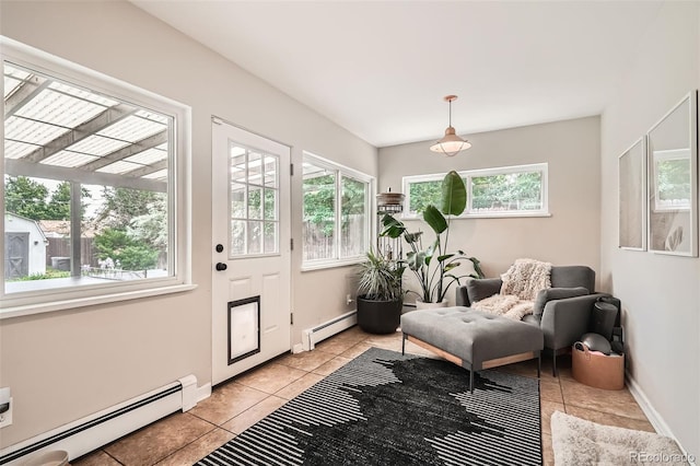 7491 W 45th Ave, Wheat Ridge, CO 80033 - living area with a baseboard radiator, light tile patterned flooring, and baseboards