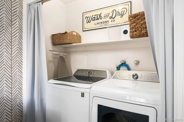 washroom featuring laundry area and washing machine and clothes dryer