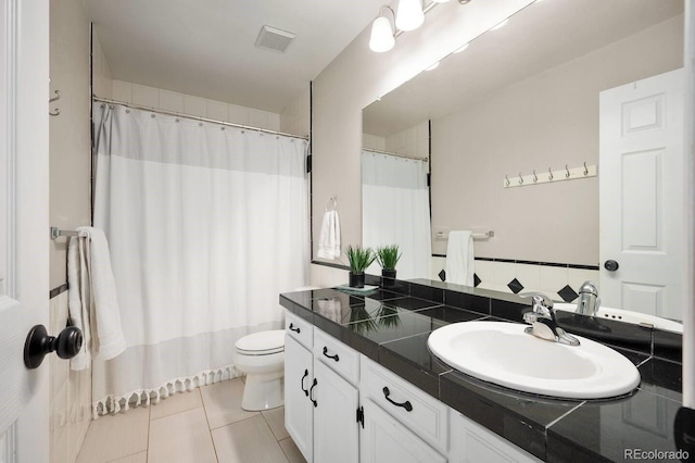 full bath with visible vents, vanity, toilet, and tile patterned floors