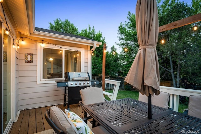 wooden deck featuring outdoor dining space and grilling area