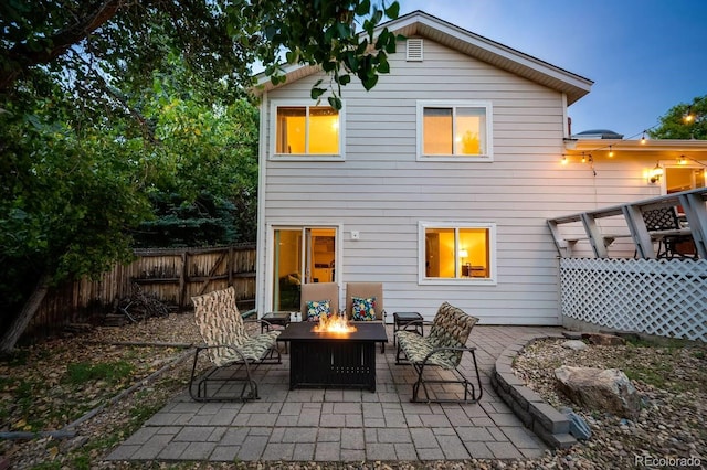 back of house featuring an outdoor fire pit, a patio area, and fence