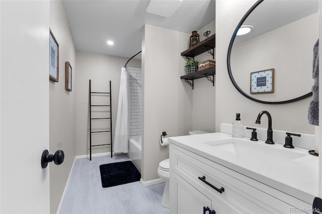 full bathroom with toilet, shower / tub combo, vanity, wood finished floors, and baseboards