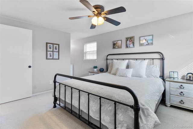 bedroom featuring light carpet, baseboards, and a ceiling fan