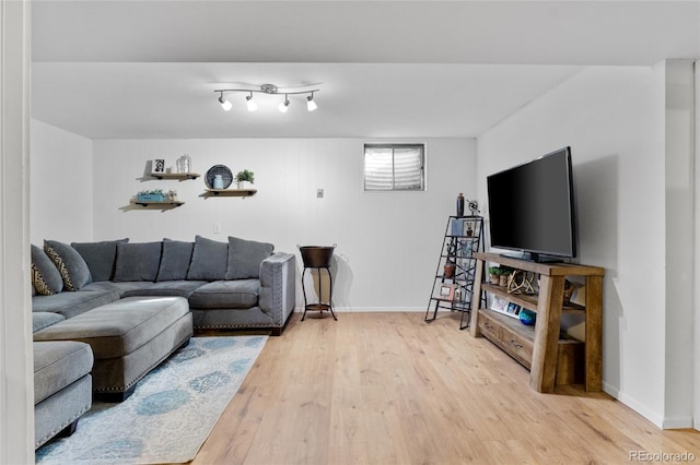 living room featuring baseboards and wood finished floors