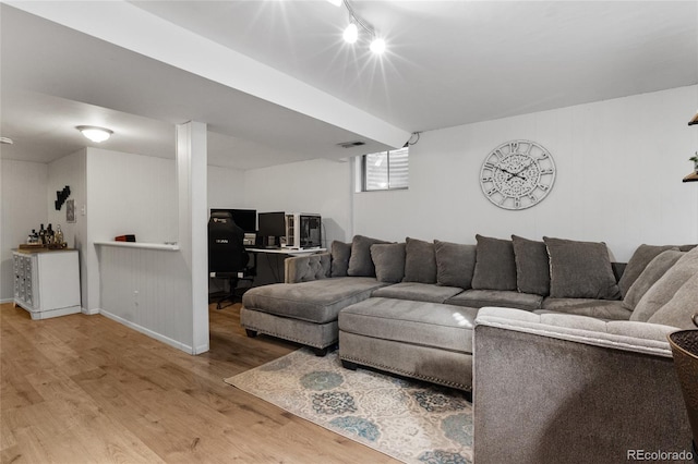 living room with wood finished floors and visible vents