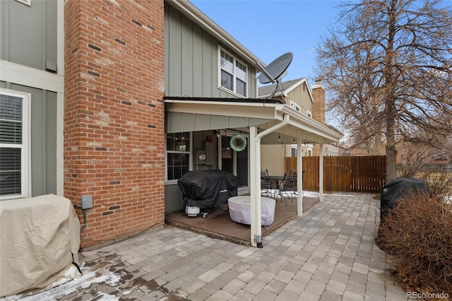 view of patio / terrace with outdoor dining space, a grill, and fence