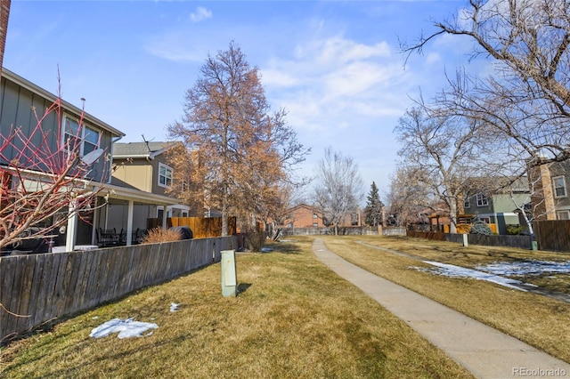 view of yard featuring fence and a residential view