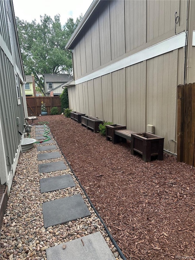 view of side of home featuring a fenced backyard