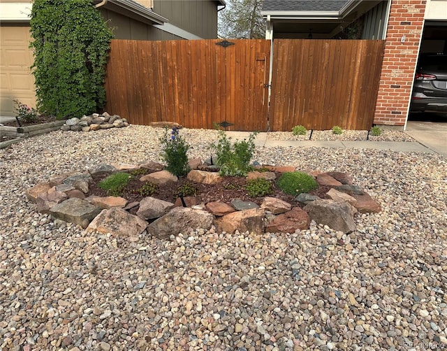 view of yard with a garage and fence