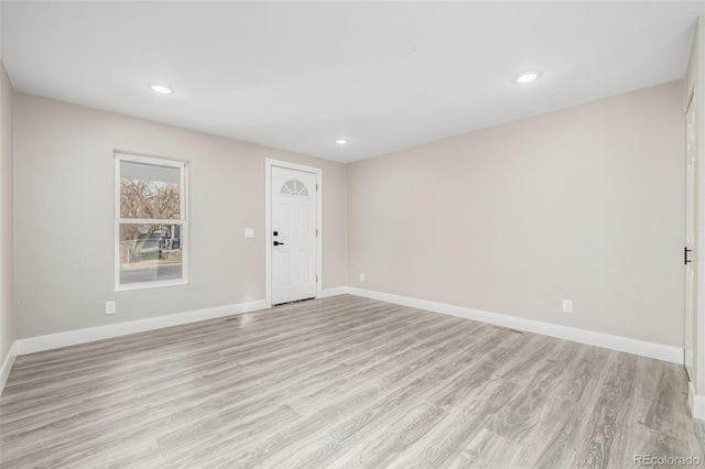 spare room with light hardwood / wood-style flooring