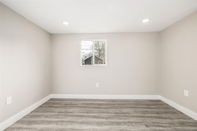 empty room with hardwood / wood-style floors