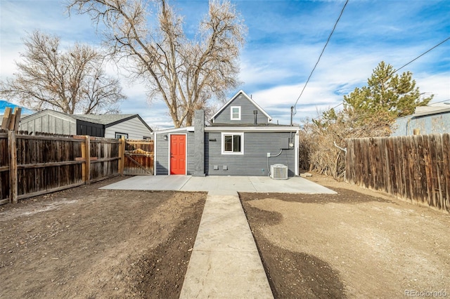 rear view of property with a patio and central AC