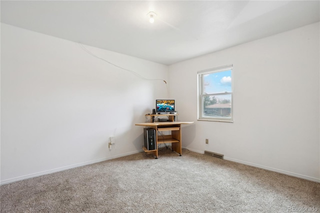 carpeted office space featuring baseboards