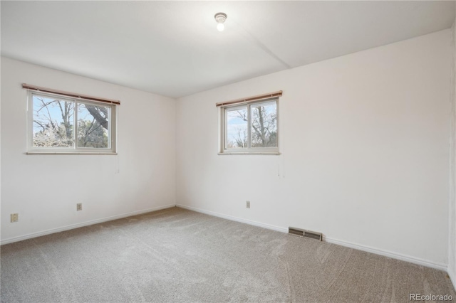 empty room with carpet floors and baseboards
