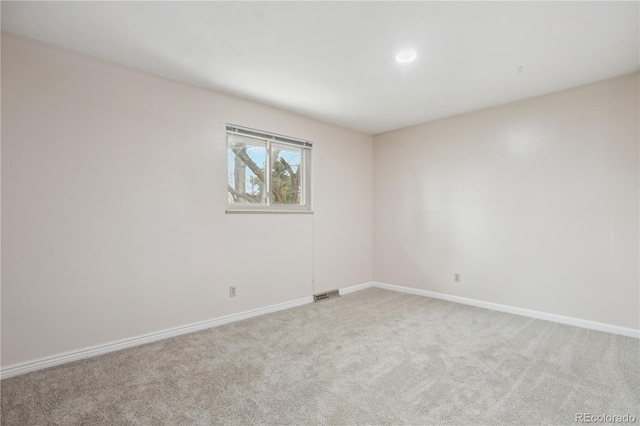 carpeted empty room with baseboards