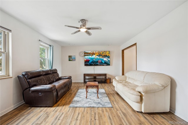 living area with ceiling fan, wood finished floors, and baseboards