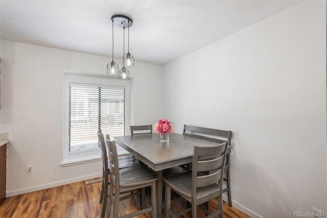 dining space with dark hardwood / wood-style flooring