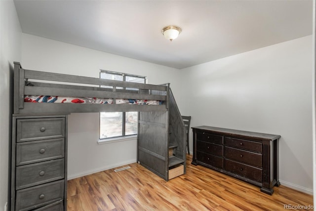 unfurnished bedroom with light wood-type flooring