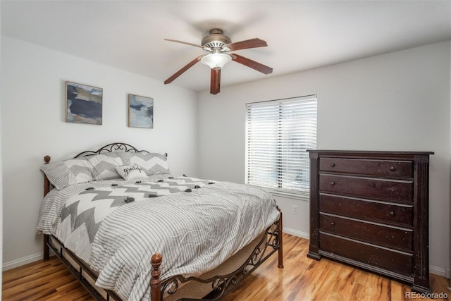 bedroom with ceiling fan and light hardwood / wood-style flooring