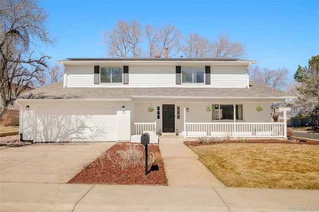 traditional-style home with a porch, a front yard, roof mounted solar panels, a garage, and driveway