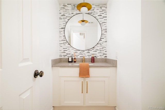 bathroom featuring tasteful backsplash and vanity