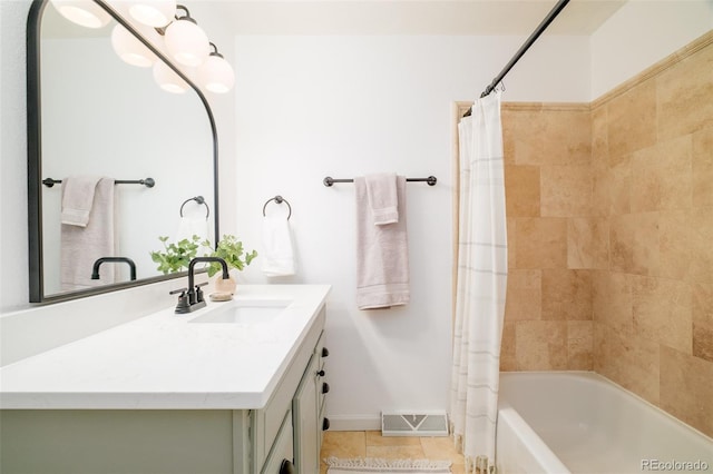 full bath with visible vents, shower / tub combo, vanity, tile patterned flooring, and baseboards