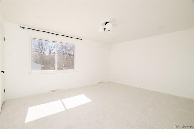 empty room with baseboards and light colored carpet