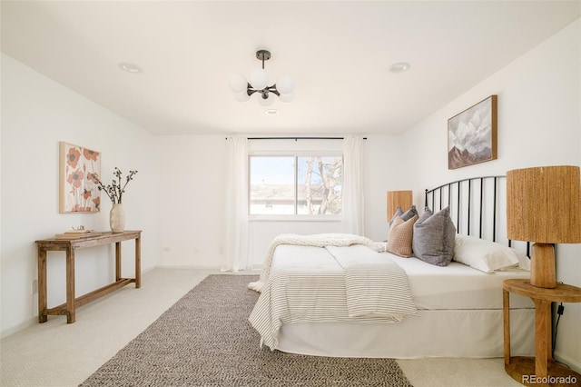 bedroom with carpet floors, baseboards, and a chandelier