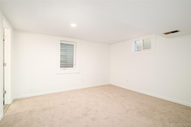 unfurnished room featuring recessed lighting, baseboards, visible vents, and light colored carpet