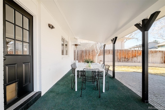 view of patio featuring outdoor dining area and fence