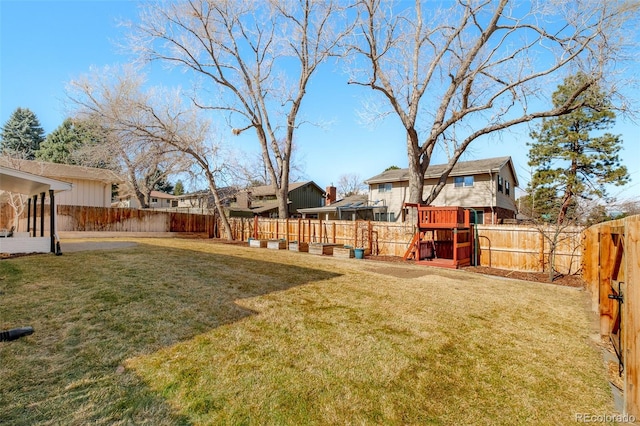 view of yard featuring a playground and a fenced backyard