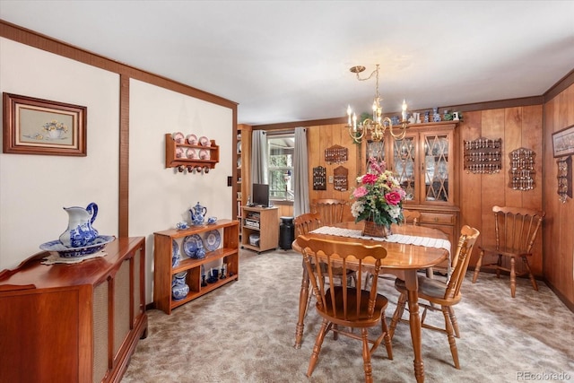1638 County Road 46, Howard, CO 81233 - dining space with a chandelier, light carpet, and wood walls