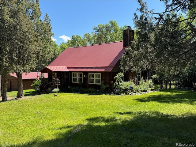 1638 County Road 46, Howard, CO 81233 - view of front facade with a chimney, a front yard, and a metal roof