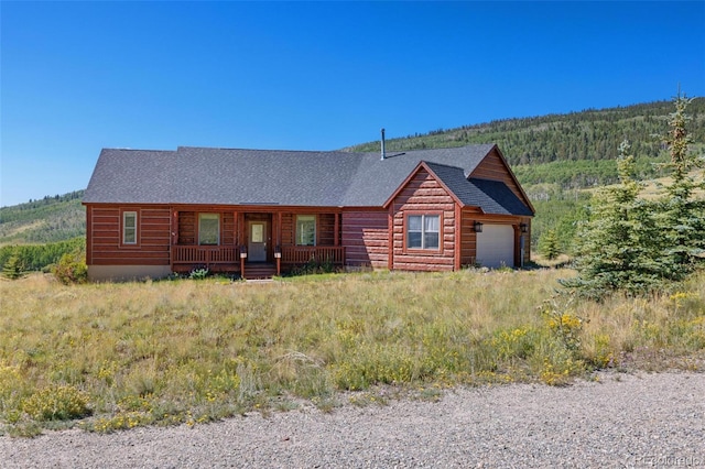 114 Round Hill Rd, Fairplay, CO 80440 - cabin featuring covered porch, roof with shingles, and a garage