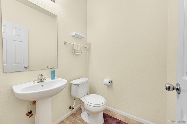 bathroom with tile patterned flooring and toilet