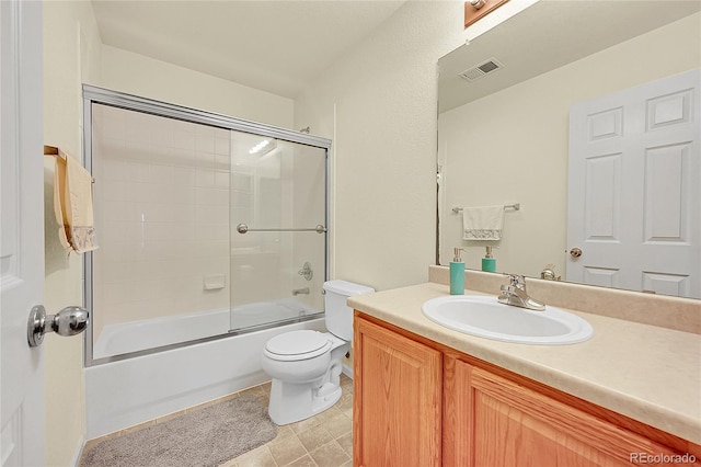 full bathroom featuring vanity, toilet, and bath / shower combo with glass door